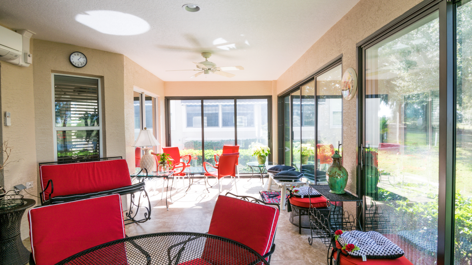 A sun room with a clock on the wall