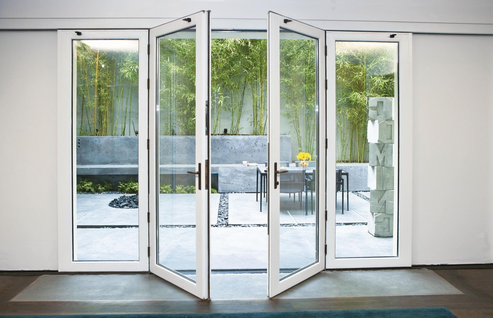 A room with a lot of glass doors leading to a patio