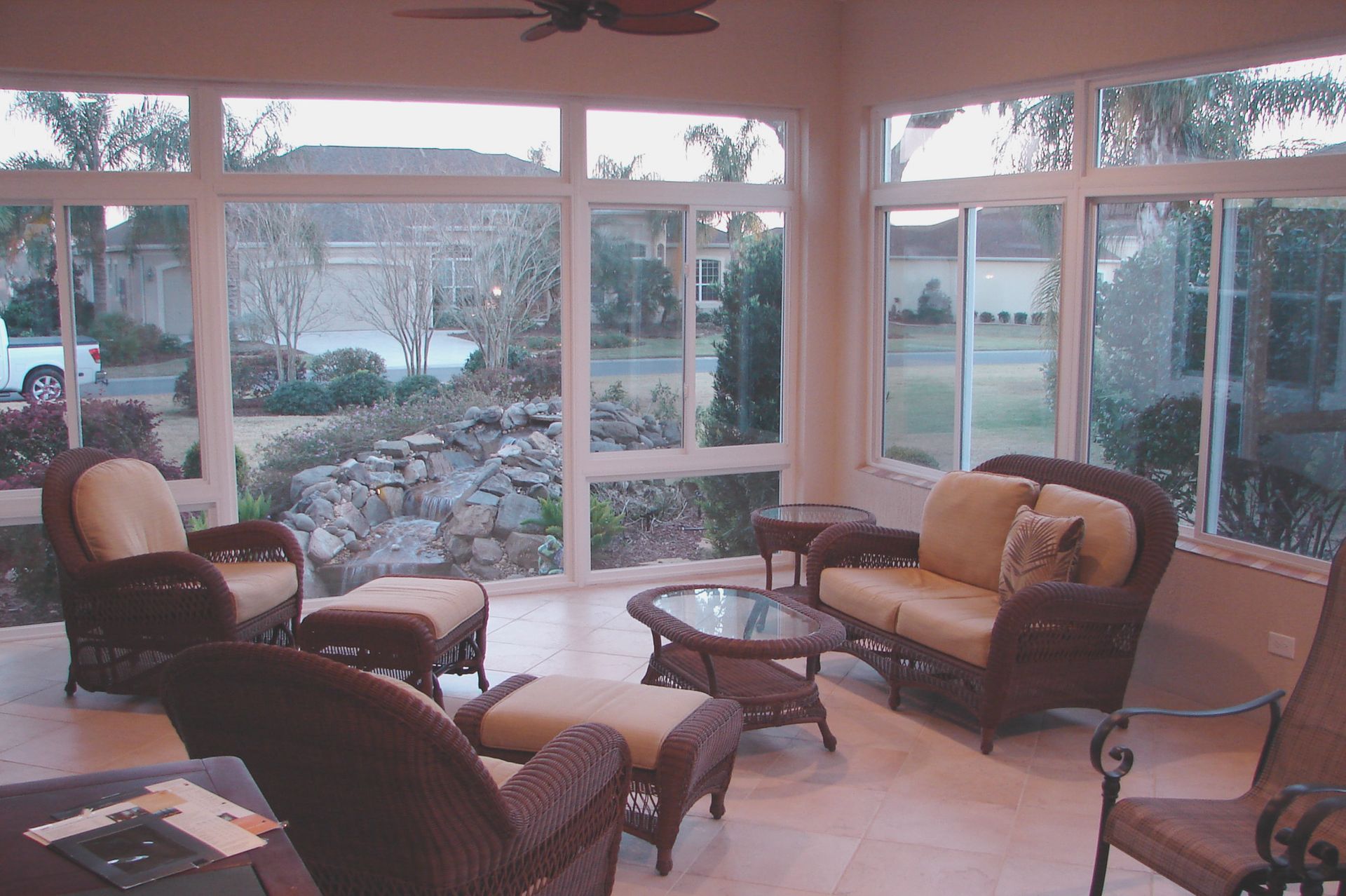 A living room with a lot of windows and furniture