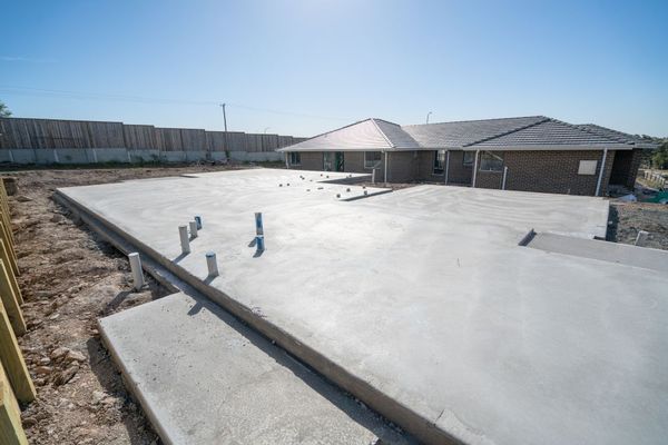 A house is being built on a concrete foundation.
