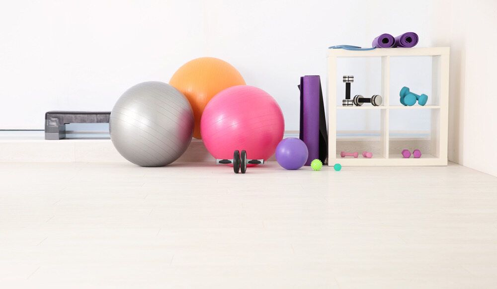 There Are Many Different Types Of Exercise Balls On The Floor — Southern Districts Physiotherapy & Sports Injuries Clinic In Albion Park, NSW