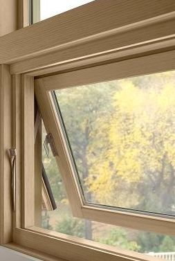 A close up of a wooden window with a view of trees in Doylestown, PA.