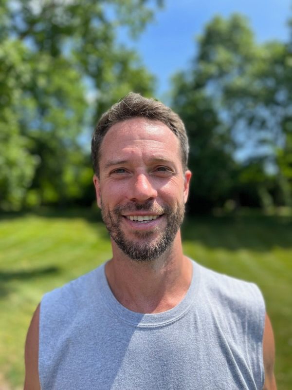 A man with a beard is wearing a window nerds t-shirt and smiling in Doylestown, PA.