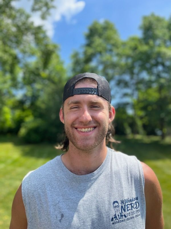 A man wearing a hat and a tank top is smiling for the camera in Doylestown, PA.