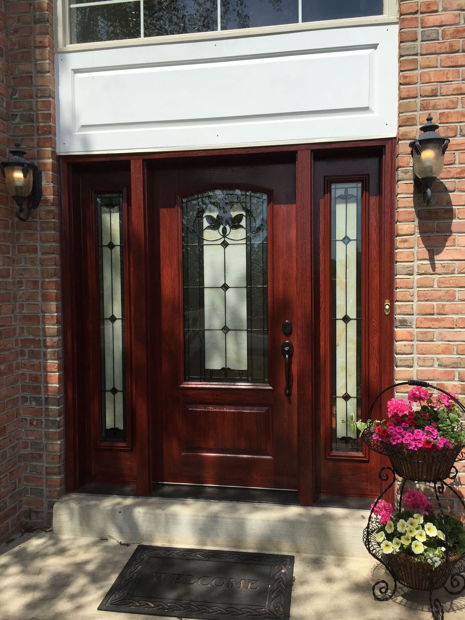 A living room with a sliding glass door and a stone wall.