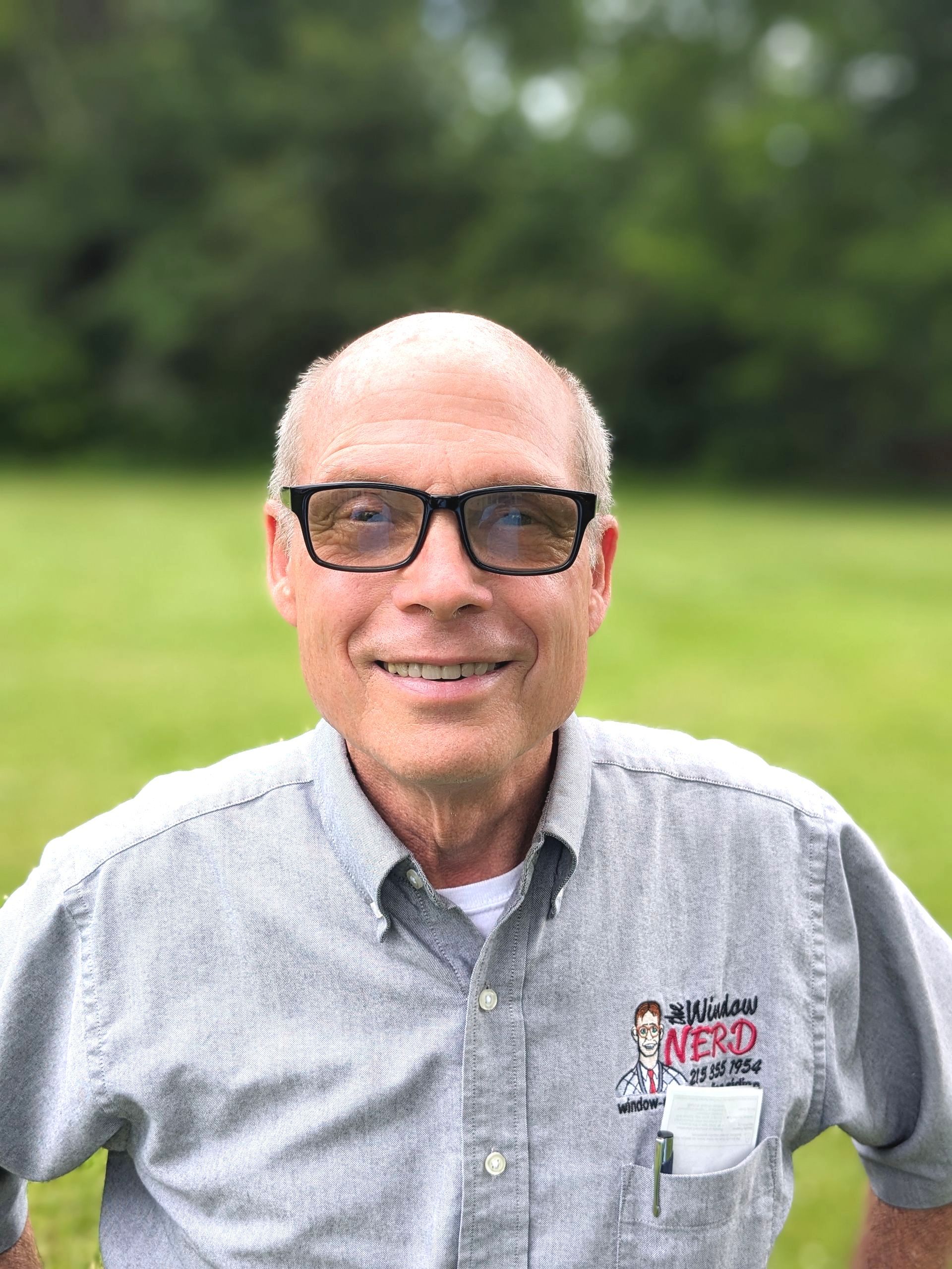 A woman wearing glasses and a necklace is smiling for the camera in Doylestown, PA.