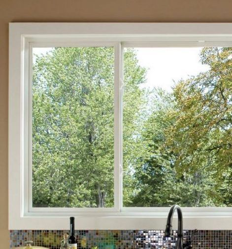 A kitchen sink with a large window overlooking the trees in Doylestown, PA.
