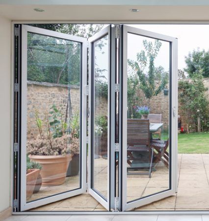 A folding glass door open to a patio with a table and chairs in Doylestown, PA.