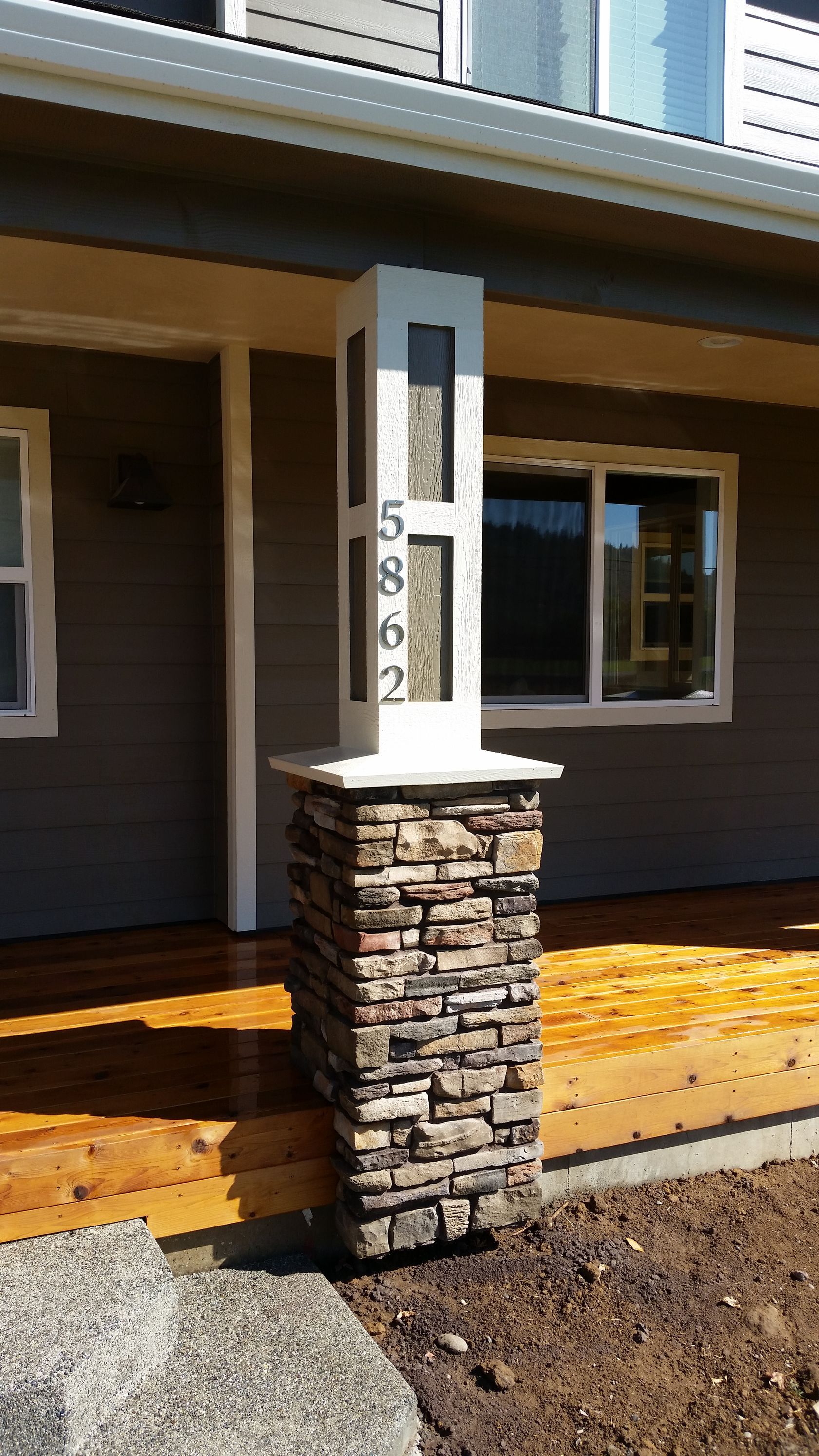 A close up of a palm tree leaf with a blue sky in the background