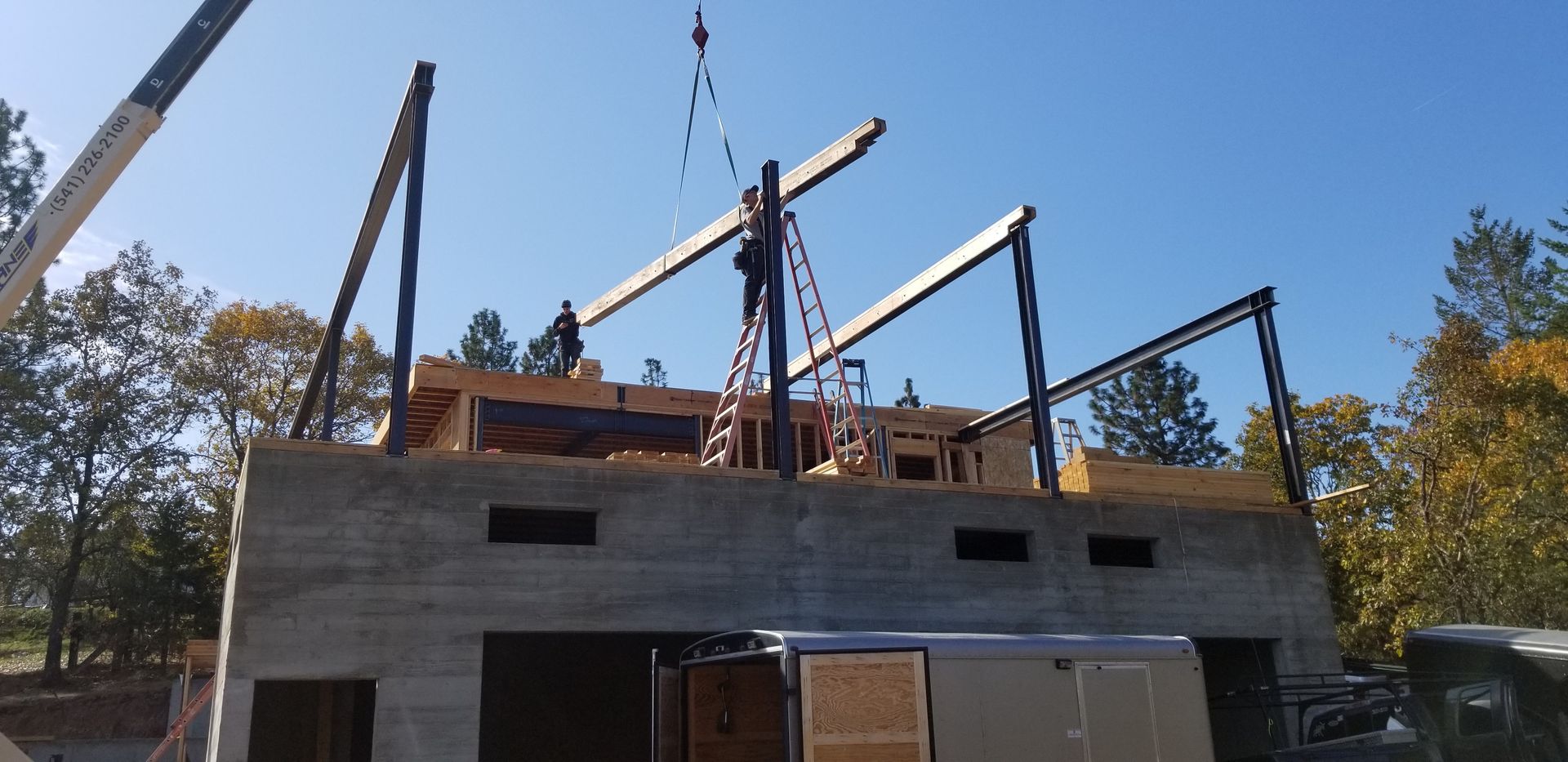 A yellow house with a tree in front of it