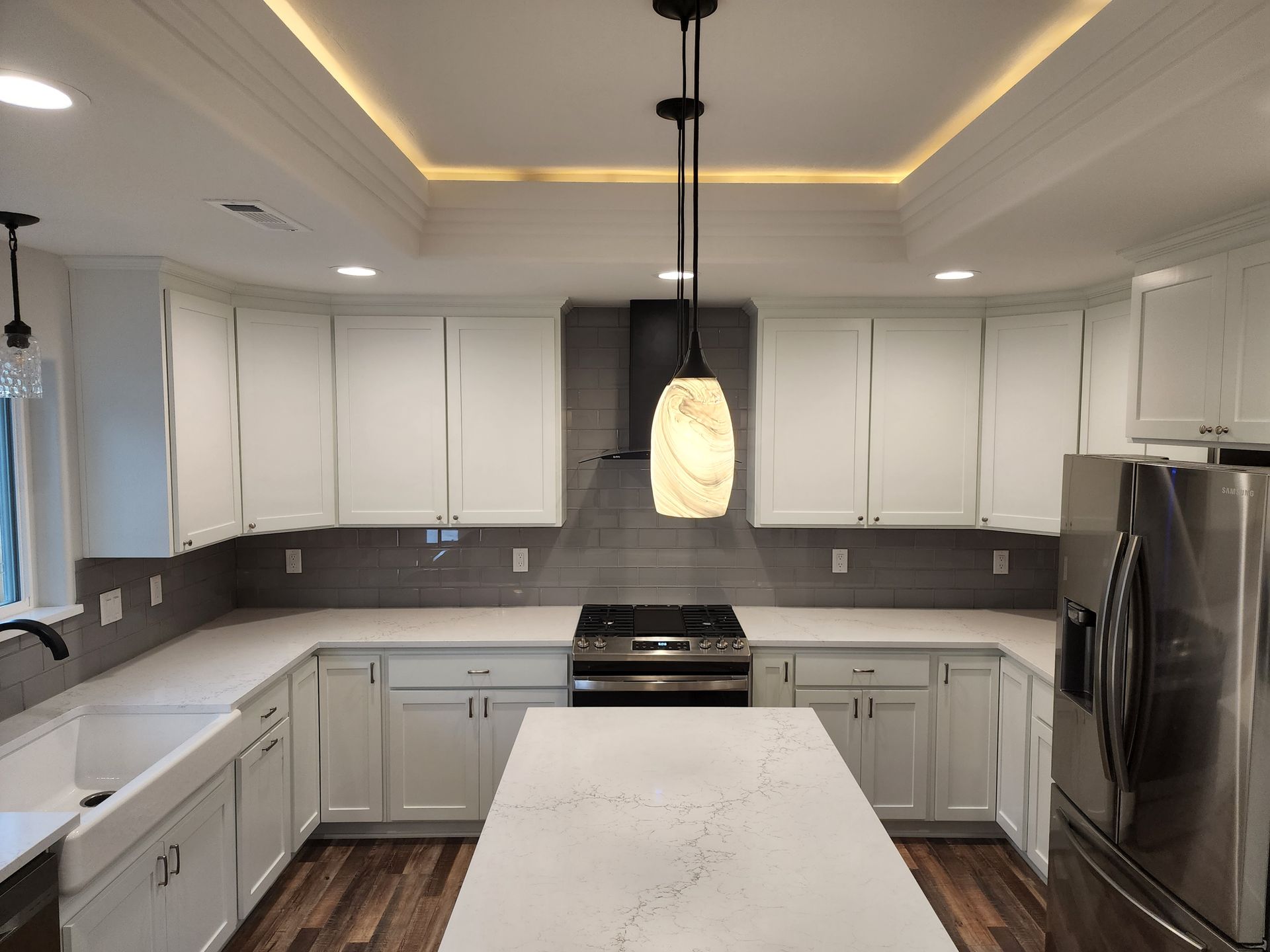 A yellow house with a tree in front of it