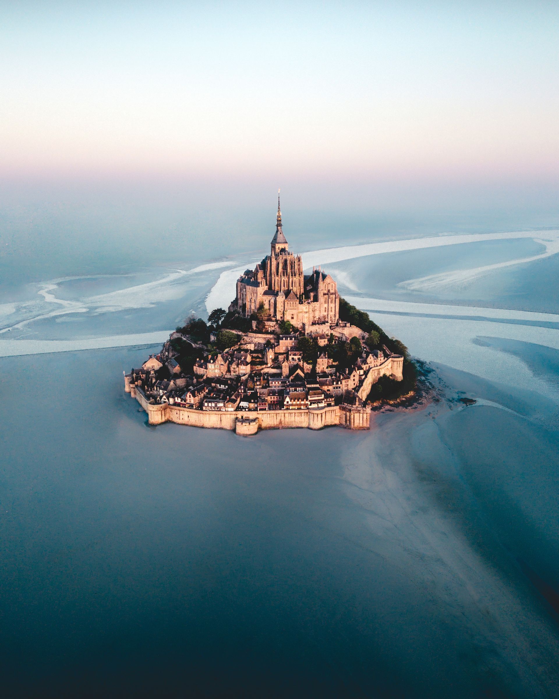 The historic citadel and Abbey Church of Mont-Saint-Michel at sunrise