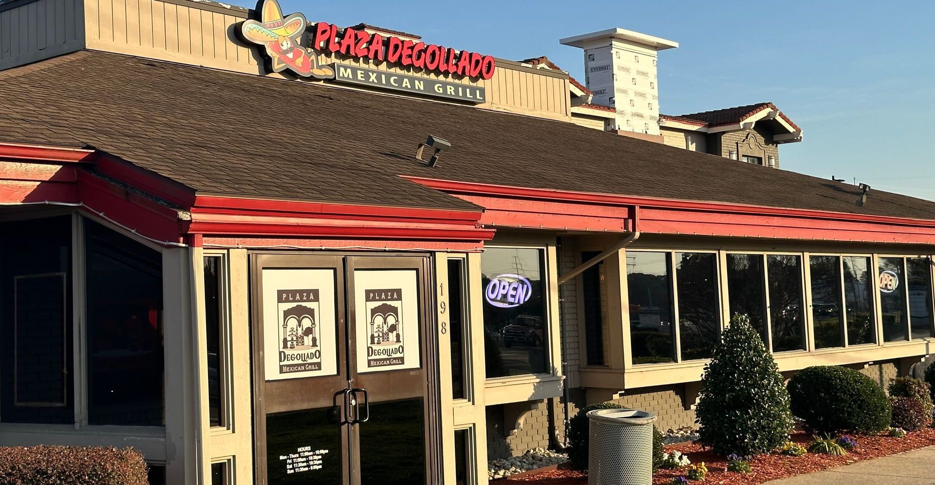 Restaurant exterior with brown roof and sign 