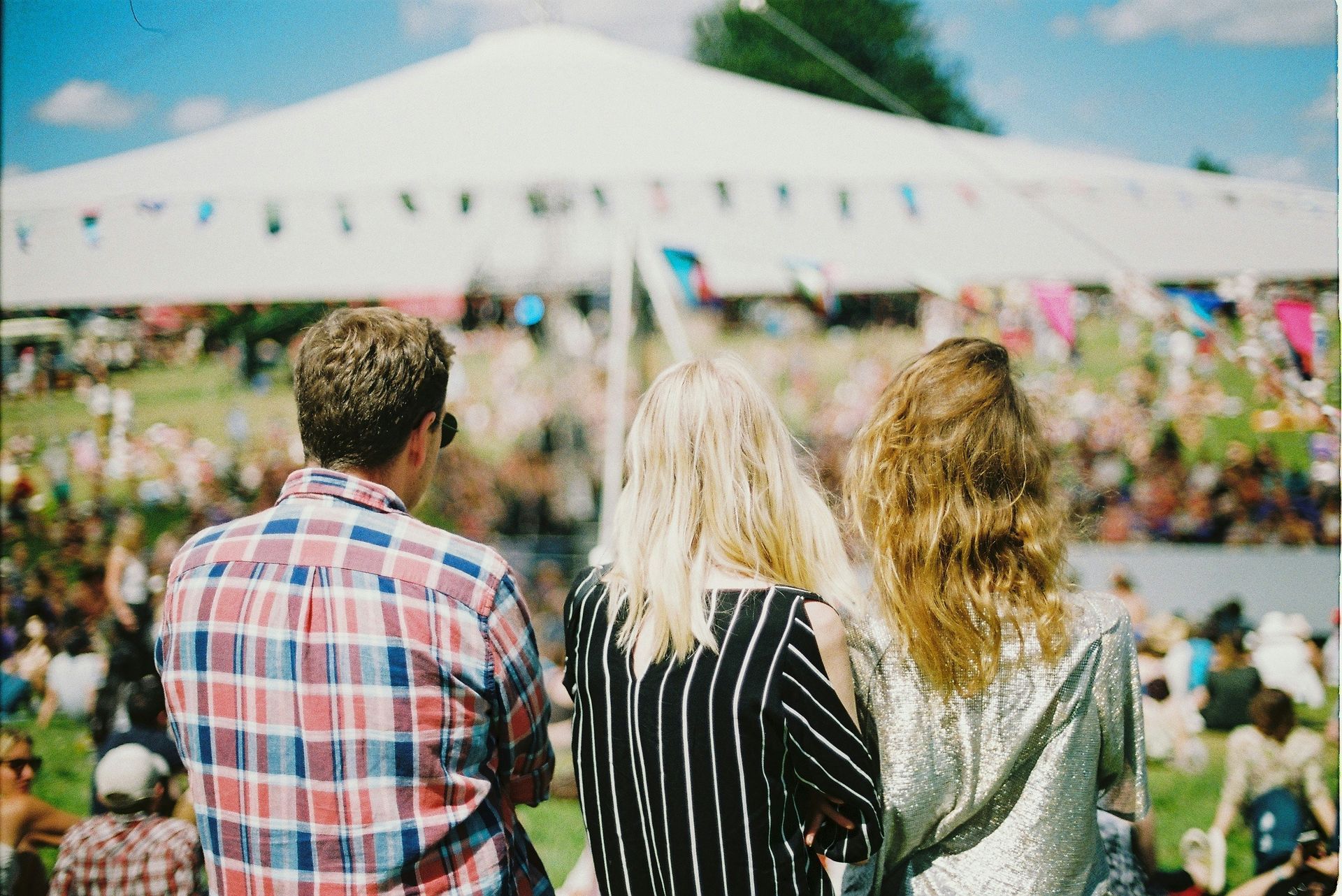 A group of people are standing in front of a crowd at a concert.