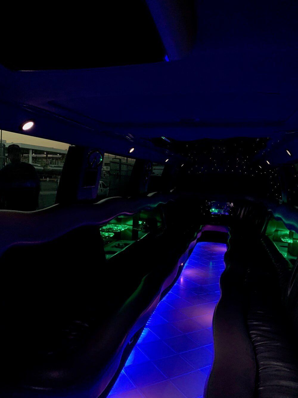 A dark room with blue and green lights on the floor