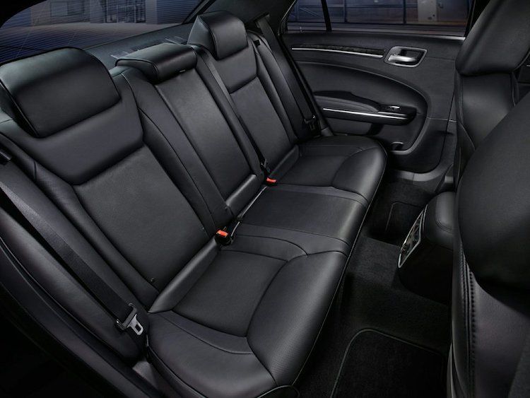 The back seat of a car with black leather seats