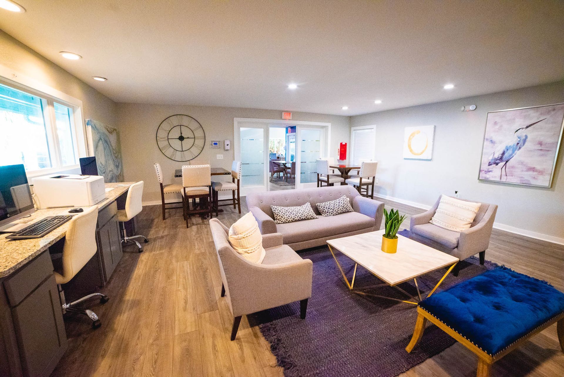 A living room filled with furniture and a computer desk at Trellis at The Lakes.