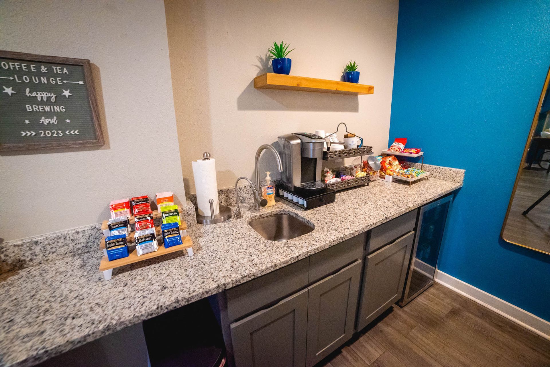 A kitchen with granite counter tops , a sink , and a coffee maker at Trellis at The Lakes.