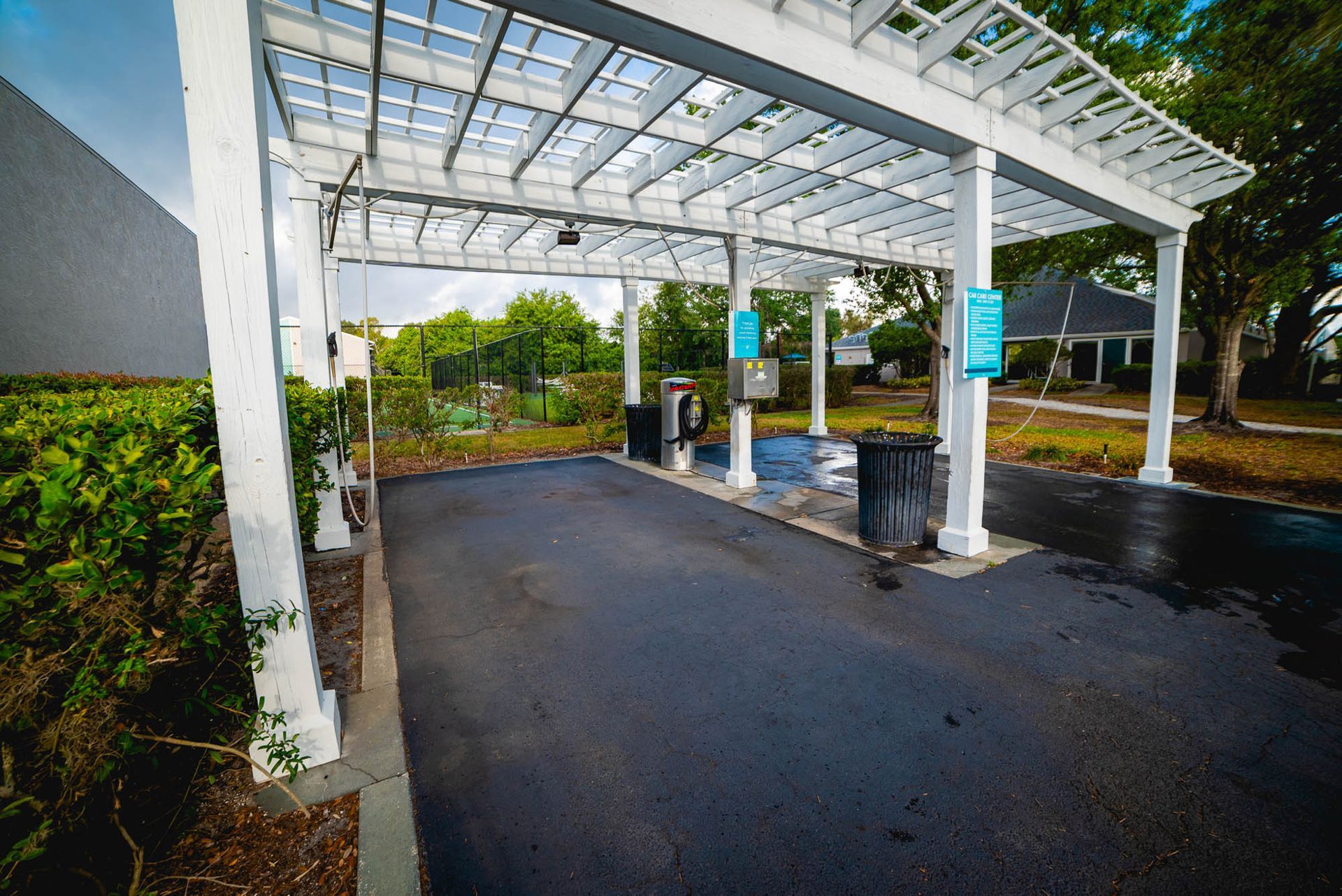 A car wash with a white pergola over the parking lot at Trellis at The Lakes.