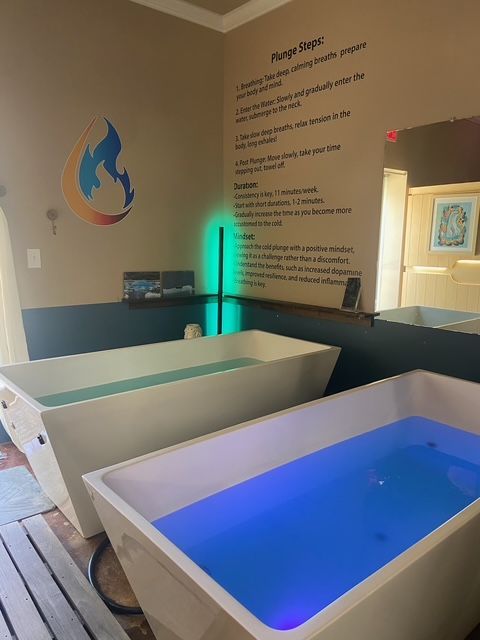 A bathroom with a sauna and a bathtub filled with water.