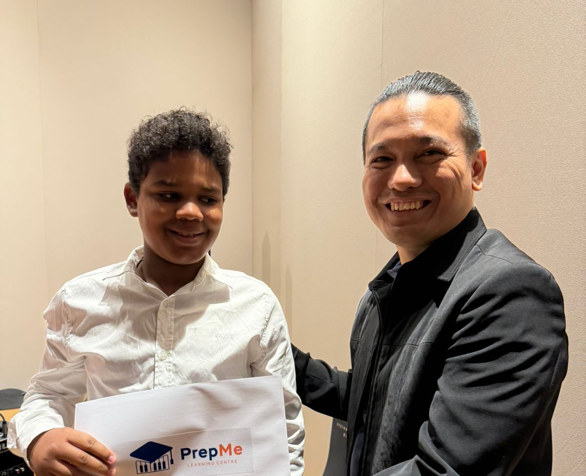 A man in a suit is holding a piece of paper that says prep me