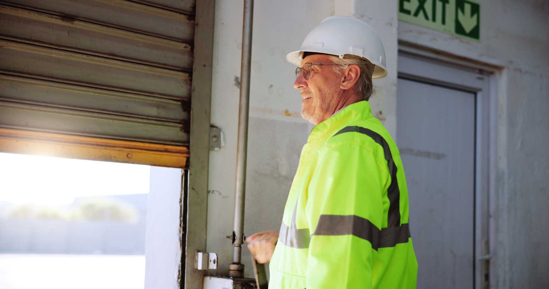 Inspector holding clipboard while examining a garage door.