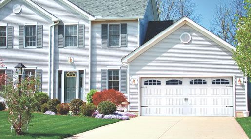 A white house with a garage and a driveway