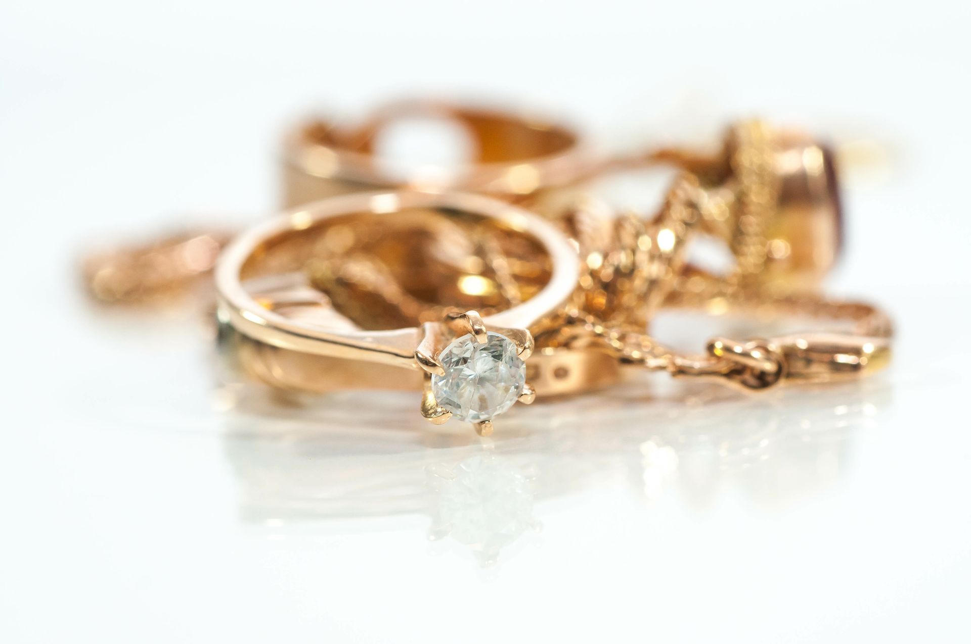 Elegant gold engagement ring and matching jewelry set on display