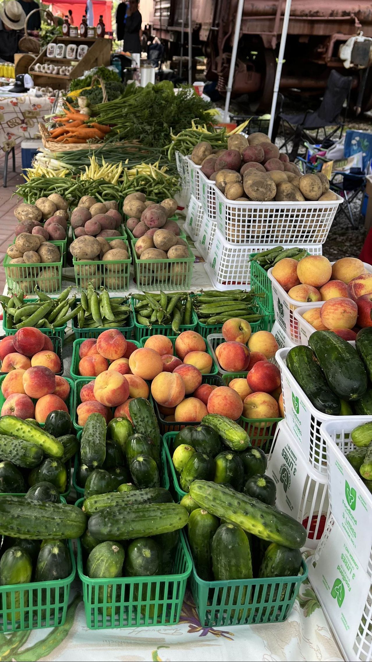 A table filled with lots of fruits and vegetables at a farmers market.
