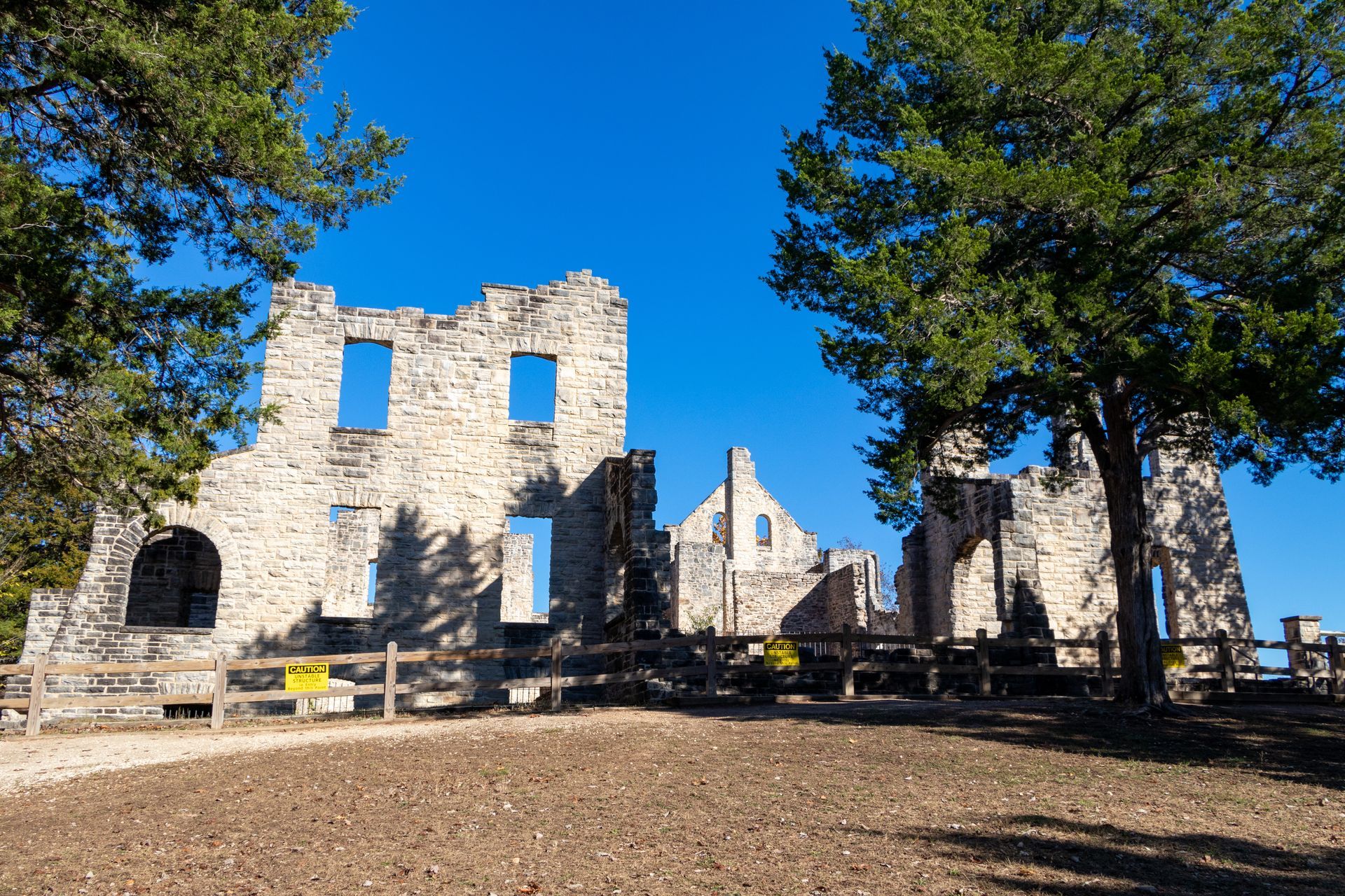 A large stone building with a blue sky in the background