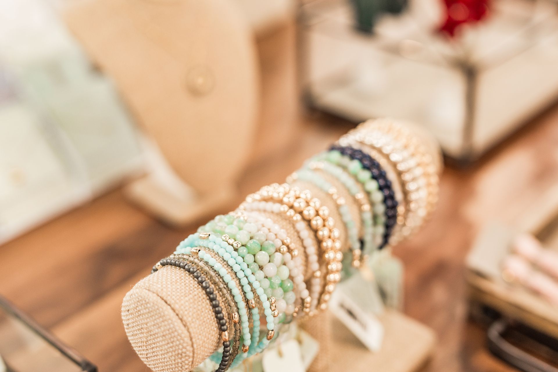 Bracelets on display stand, various colors and textures, shop setting.