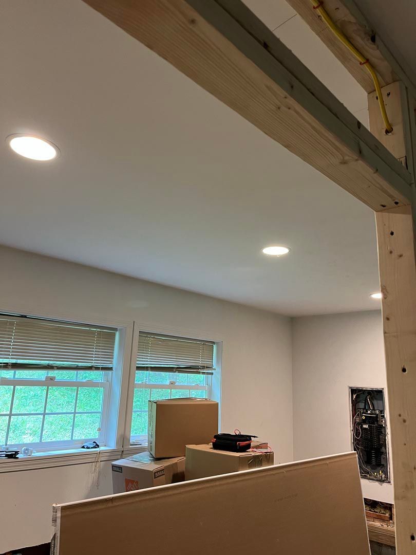 A room with a lot of boxes on the floor and a window.