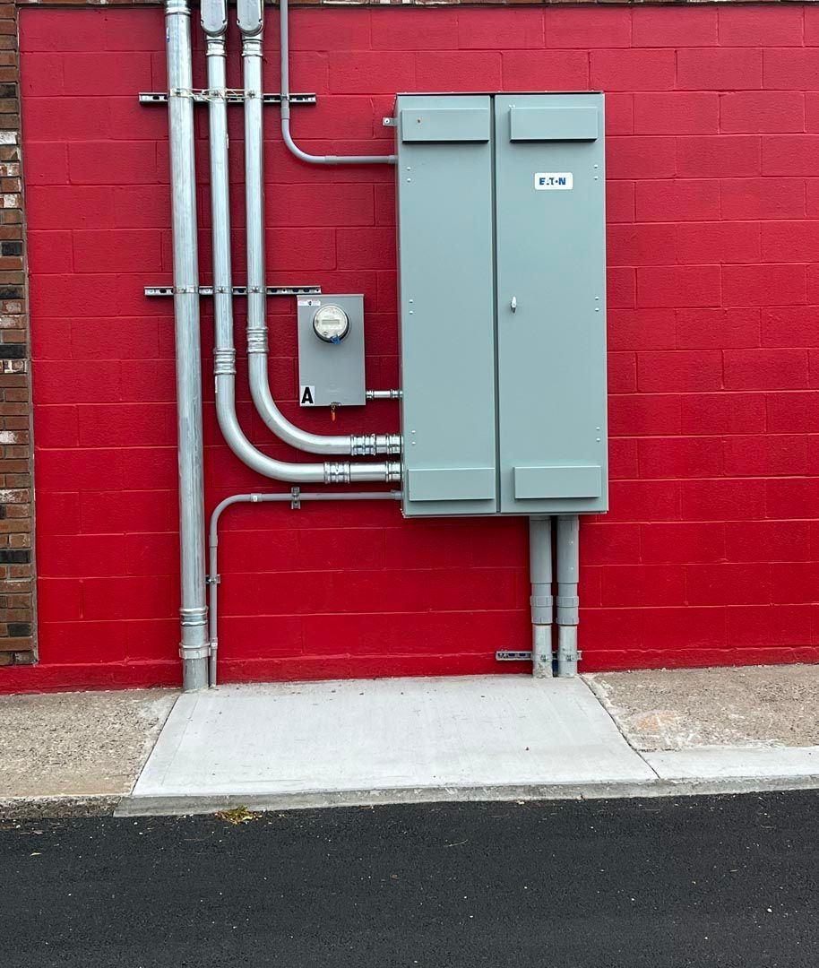 A red brick wall with a gray box on it