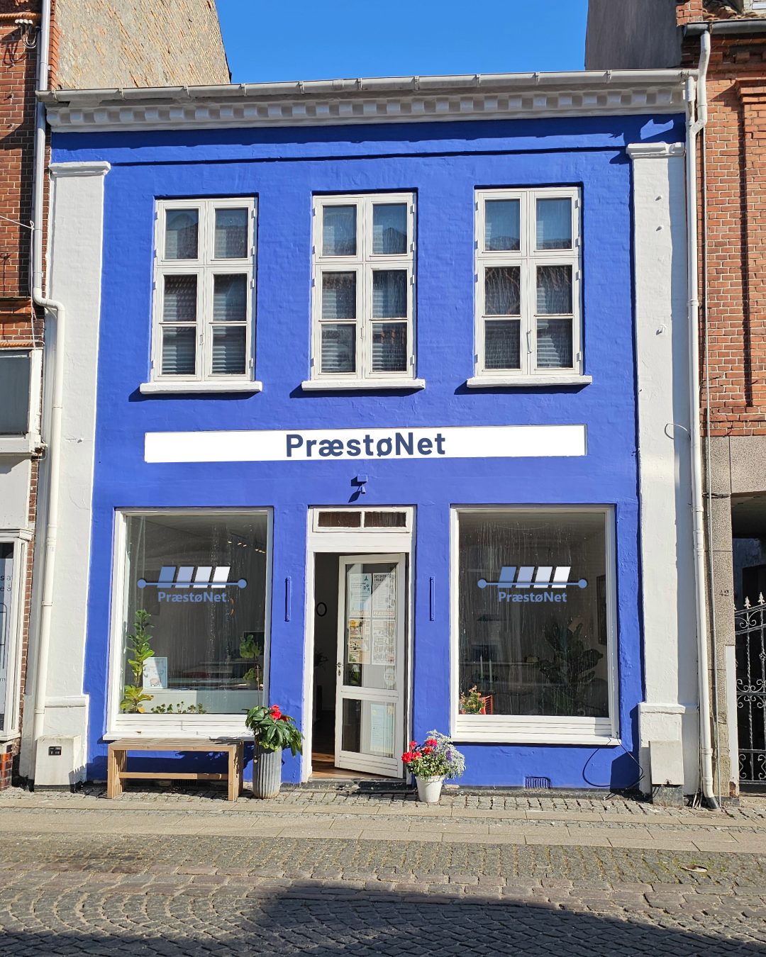 En blå bygning med PræstøNet på