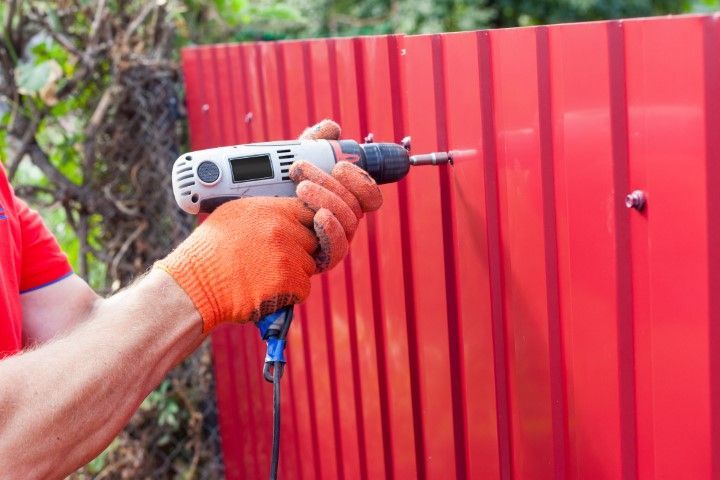 Lake Oswego Fence Pro installing metal fence section.