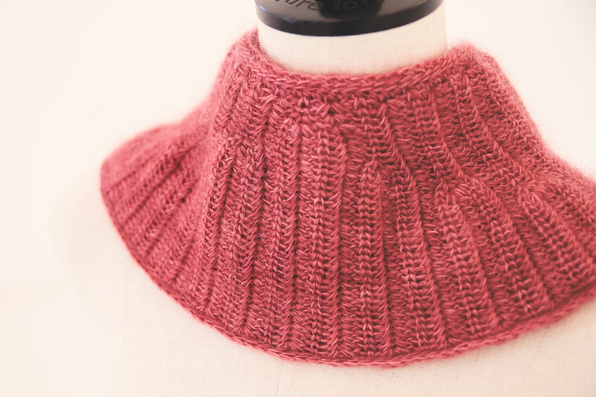 Red knitted cowl neck collar.