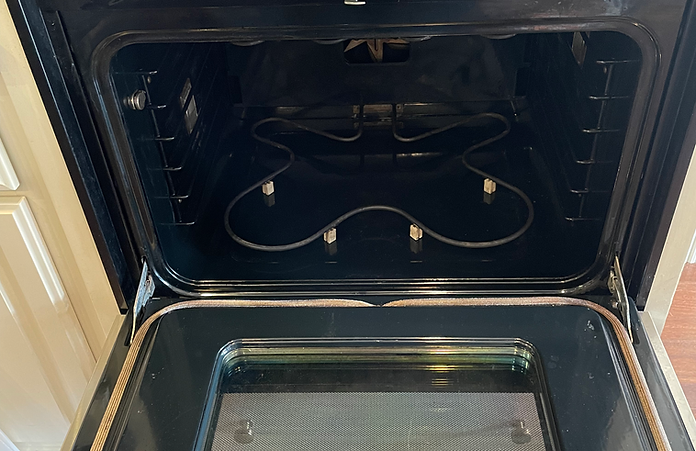 The inside of an oven is shown with the door open.