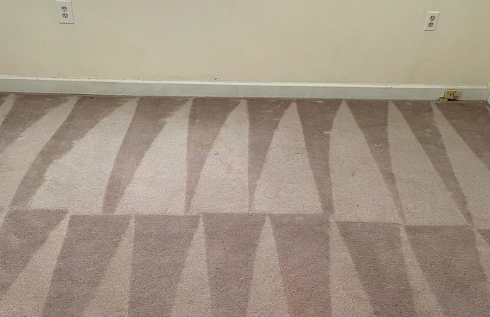 A carpet in a room with a geometric pattern on it.