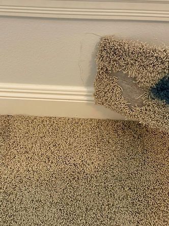 A piece of carpet is sitting on the floor next to a wall.