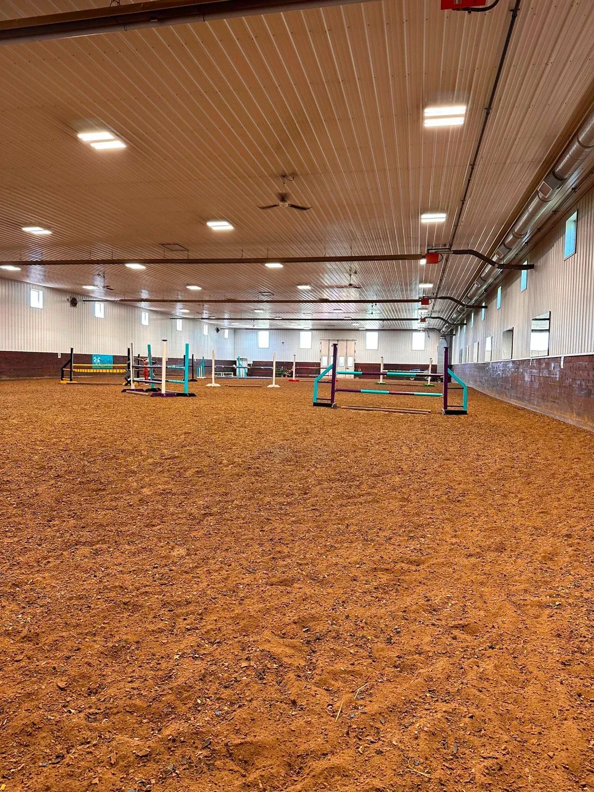 Indoor equestrian arena with jumps