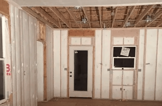 A room with a door and a window is being built.