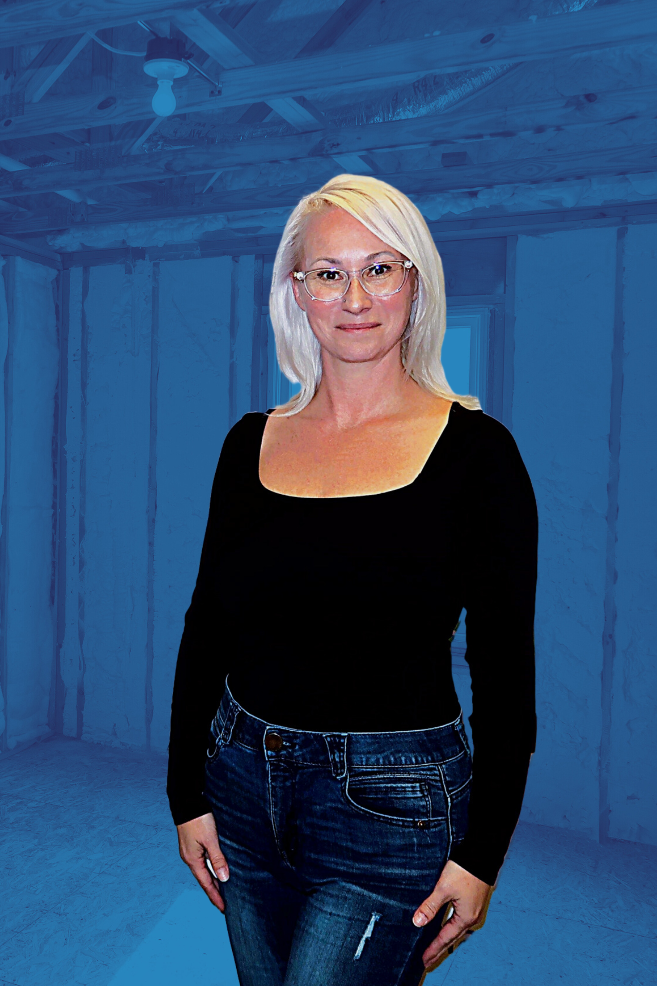A woman wearing glasses and a black shirt is standing in front of a blue wall.