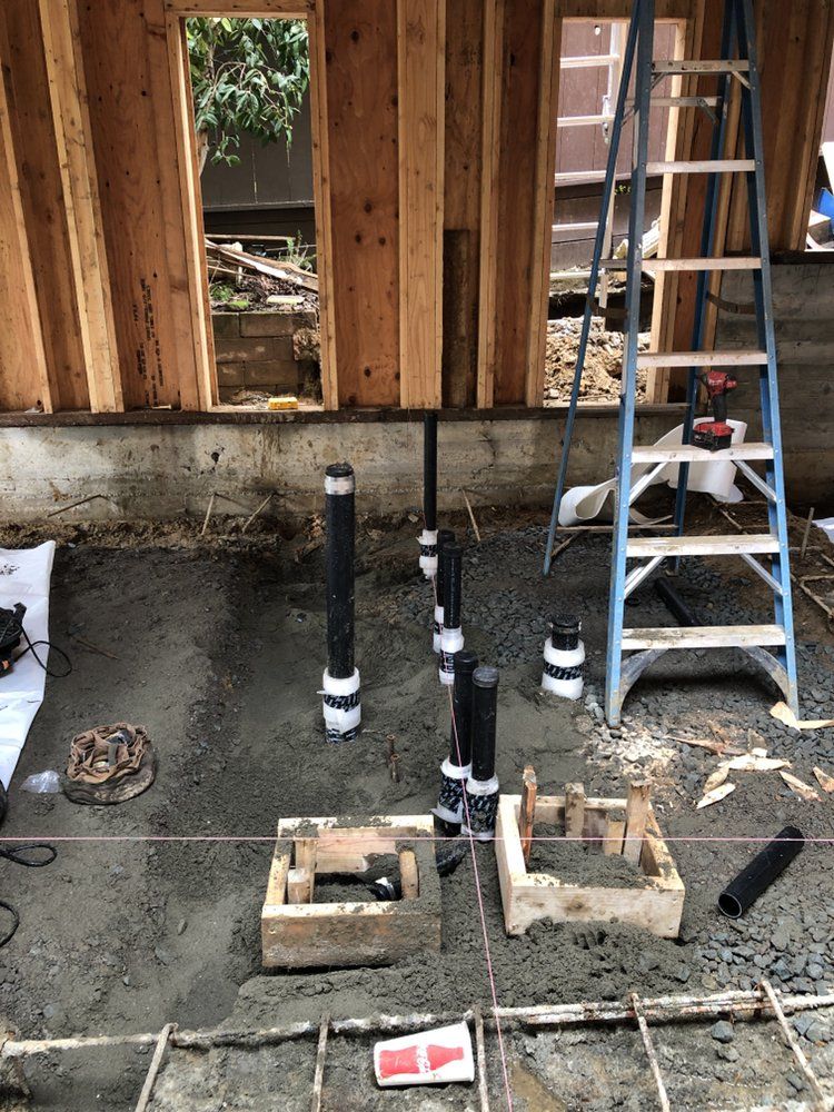 A Ladder Is Sitting on The Ground in Front of A Building Under Construction – Hayward, Ca – Plumbing 1 Builders Inc.