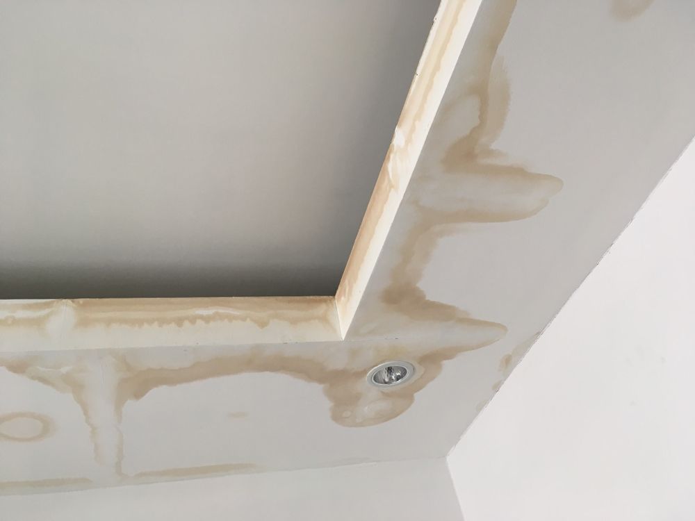 A Close Up of a Ceiling With a Wooden Frame and a Hole in It — Knobel Builders In Balgownie, NSW