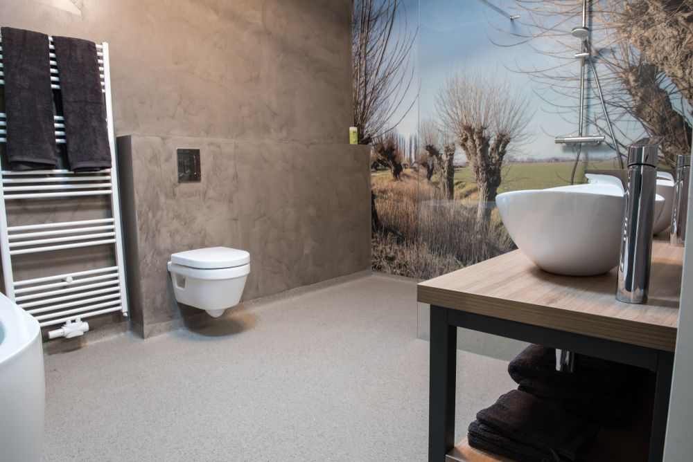 A Bathroom With a Toilet, Sink, and Towel Rack — Knobel Builders In Shellharbour, NSW