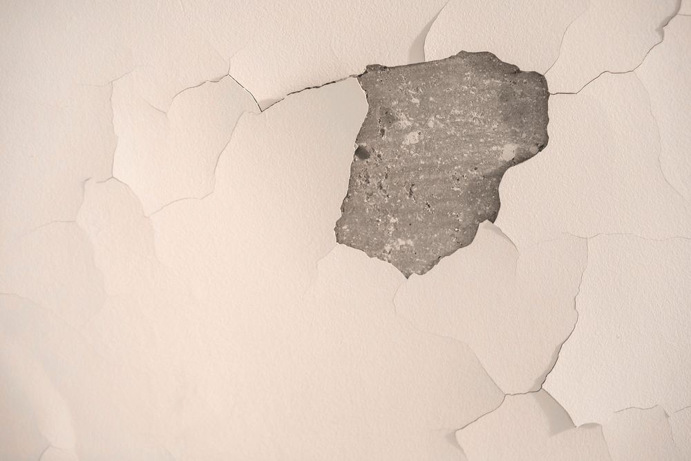 A Piece of Concrete is Sticking Out of a Hole in a Wall — Knobel Builders In Balgownie, NSW
