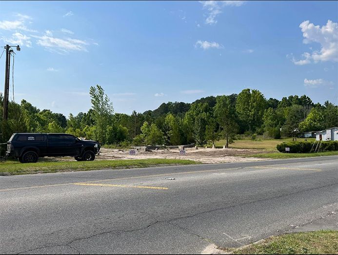 A black truck is parked on the side of the road