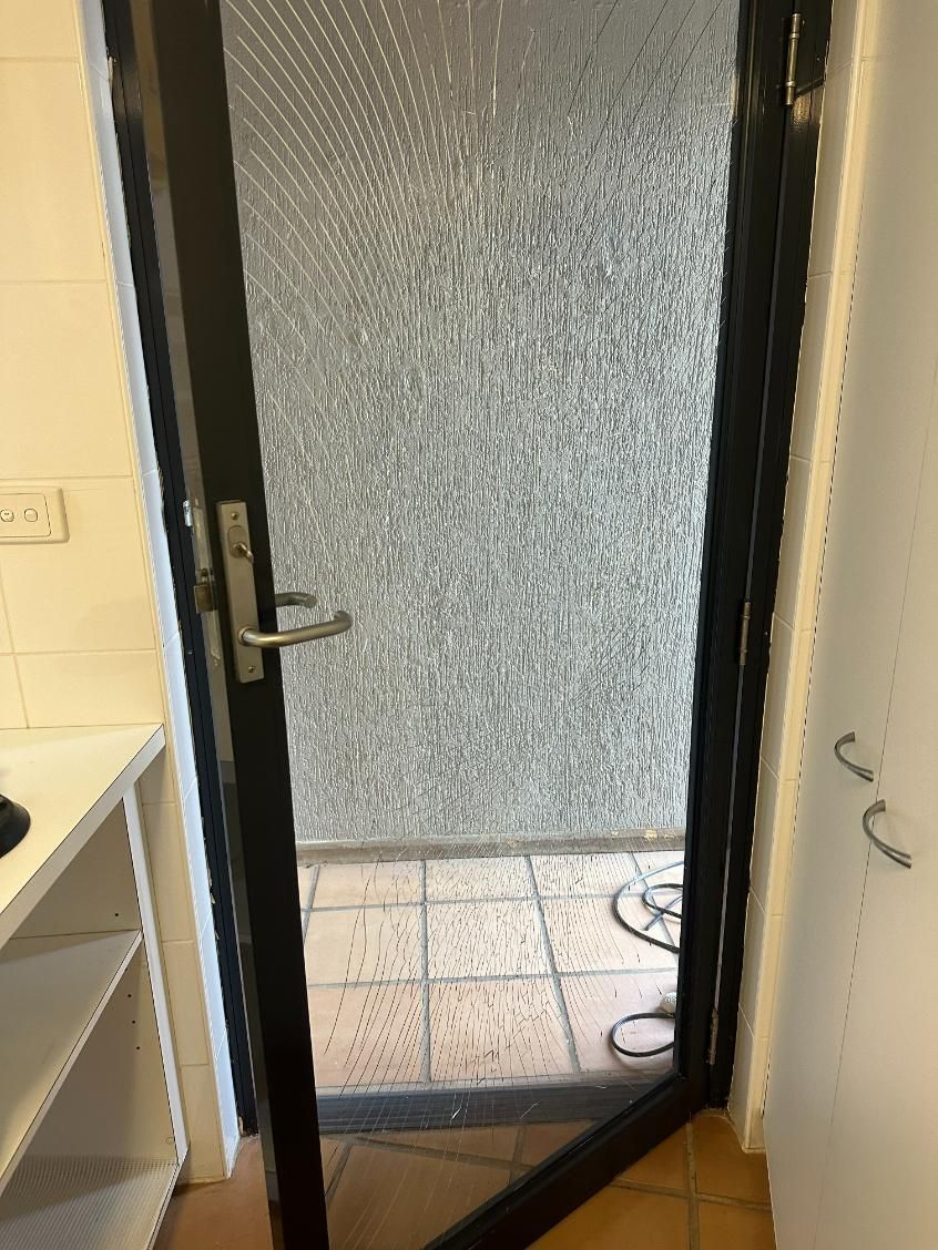 A Door With A Screen On It Is Open In A Room — Central Coast Glass & Glazing In Bateau Bay, NSW