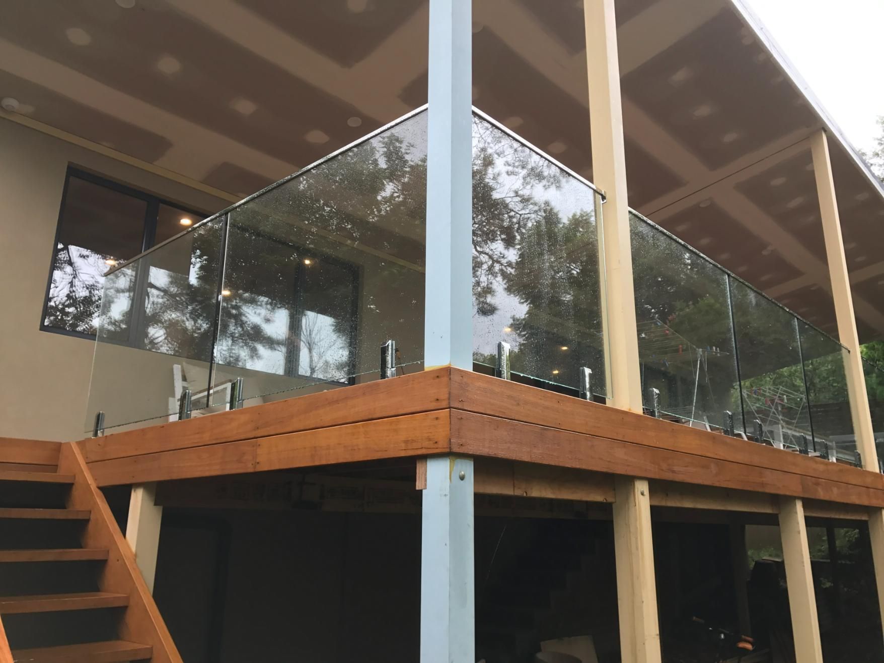 A Wooden Deck With A Glass Railing And Stairs — Central Coast Glass & Glazing In Umina Beach, NSW