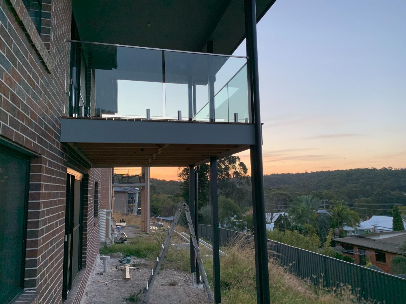 A House With A Balcony And A View Of A Sunset — Central Coast Glass & Glazing In Umina Beach, NSW